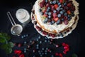 Beautiful, fruit naked cake on a dark tablecloth