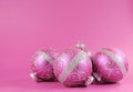 Beautiful fuchsia pink festive bauble ornaments on a feminine pink background with copy space