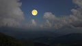 Beautiful full moon over the valleys in the mountains