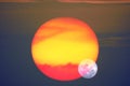 Beautiful full moon on night sky and reflection close up to red yelllow sunset on glass of window