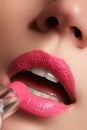 Beautiful full pink lips. Lipstick. Professional make-up