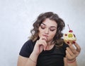 Beautiful full pretty girl expression thoughtful sweet food baking cake surprise emotions delicious Royalty Free Stock Photo