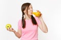 Beautiful fun happy woman holding in hands green apple and orange fresh juice in glass isolated on white background Royalty Free Stock Photo