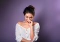 Beautiful fun humor laughing woman in white shirt covering the mouth the hands. Closeup portrait on empty purple copy space.