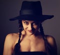 Beautiful fun positive young woman in style blue hat smiling on dark shadow background. Closeup portrait. Halloween kind concept.