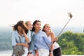 Beautiful funny girlfriends make selfies in the mountains on the background of nature. travel, summer, weekend, walk