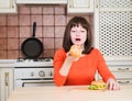 Beautiful funny young woman eating french bread pizza and burger Royalty Free Stock Photo