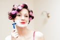 Beautiful funny girl shaving with foam & razor her face