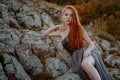 Beautiful furious scandinavian warrior ginger woman in grey dress