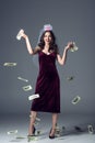 beautiful future bride in veil for bachelorette party throwing money away and looking at camera Royalty Free Stock Photo