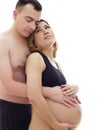 Beautiful future parents: his pregnant asian wife and a happy husband acting hug together Royalty Free Stock Photo