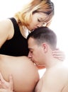 Beautiful future parents: his pregnant asian wife and a happy husband acting kiss together