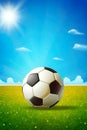 beautiful game with a soccer ball on a grassy field under a clear blue sky. Royalty Free Stock Photo
