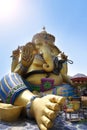Beautiful Ganesha sitting comfortably outdoors in blue sky