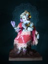 Beautiful Ganesha statue in the pose of Lord Krishna. Handcrafted, cute Ganesh murti on background