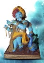 Beautiful Ganesha statue in the pose of Lord Krishna. Handcrafted, cute Ganesh murti on isolated background