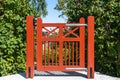 Beautiful Garden design. Authentic red color modern gate entrance to the garden. Countryside authentic cozy little house courtyard Royalty Free Stock Photo
