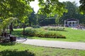 Beautiful garden with green grass, flowers and trees Royalty Free Stock Photo