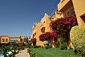 Beautiful garden at hotel resort and building in traditional arabic style. Resort architecture in Egypt Royalty Free Stock Photo