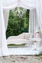 Beautiful garden seating area with modern white sofa, canopy and tea table, gazebo decor idea. Royalty Free Stock Photo