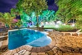 Beautiful garden with trees, pool and grass at night Royalty Free Stock Photo