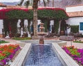 Beautiful garden with a water fountain and blooming flowers in La Quinta