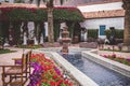 Beautiful garden with a water fountain and blooming flowers in La Quinta