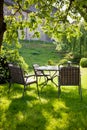 Beautiful garden with white table and chair Royalty Free Stock Photo