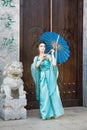 Beautiful geisha with a blue umbrella Royalty Free Stock Photo