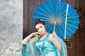 Beautiful geisha with a blue umbrella Royalty Free Stock Photo