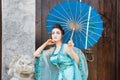 Beautiful geisha with a blue umbrella Royalty Free Stock Photo