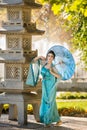 Beautiful geisha with a blue umbrella Royalty Free Stock Photo