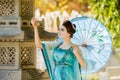 Beautiful geisha with a blue umbrella Royalty Free Stock Photo