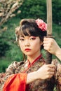 Beautiful geisha in kimono with samurai sword Royalty Free Stock Photo