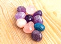 Beautiful gems, acrobatic stones from amethyst, rose quartz and apatite. Purple and pink magic crystals on a wooden background Royalty Free Stock Photo