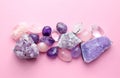 Beautiful gemstones and druses of natural purple mineral amethyst on a pink background. Amethysts and rose quartz. Large crystals Royalty Free Stock Photo