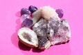 Beautiful gemstones,  geode of  amethyst and druses of natural purple mineral amethyst on a bright pink background. Amethysts and Royalty Free Stock Photo