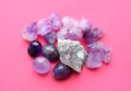 Beautiful gemstones,  geode of  amethyst and druses of natural purple mineral amethyst on a bright pink background. Amethysts and Royalty Free Stock Photo