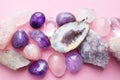 Beautiful gemstones,  geode amethyst and druses of natural purple mineral amethyst on a pink background. Amethysts and rose quartz Royalty Free Stock Photo