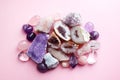 Beautiful gemstones,  geode amethyst and druses of natural purple mineral amethyst on a pink background. Amethysts and rose quartz Royalty Free Stock Photo