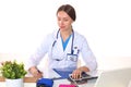 Beautiful general practitioner is working with joy. She is standing with a folder of documents in her hand Royalty Free Stock Photo