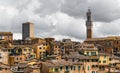 Beautiful generic architecture with buildings and towers under cloudy sky in Siena, Tuscany, Italy. Royalty Free Stock Photo