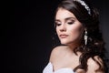 Beautiful gentle girl portraits of the bride in a white wedding dress with evening hairstyle with a rim of flowers in her hair and Royalty Free Stock Photo