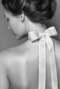 Beautiful gentle girl with silk bow on the back Royalty Free Stock Photo