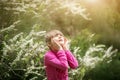 Beautiful gentle girl standing in a lush garden Royalty Free Stock Photo