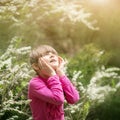 Beautiful gentle girl standing in a lush garden Royalty Free Stock Photo