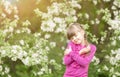 Beautiful gentle girl standing in a lush garden