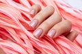 Beautiful gentle manicure. Close-up woman`s hand holds a pink leaf