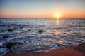 Beautiful gentle sunset at the sea, bright sun and pebble beach Royalty Free Stock Photo