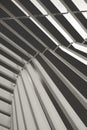 Beautiful geometric abstraction of parallel non-intersecting metal columns and elements with a light source from behind. Vertical